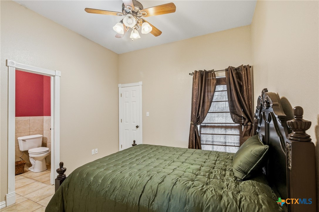 1739 Old Goliad Road Victoria, TX 77905 - Photo 24 of 43 a bedroom with a bed and wooden floor