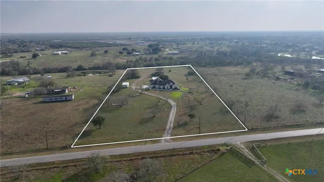 an aerial view of a house with a lake view