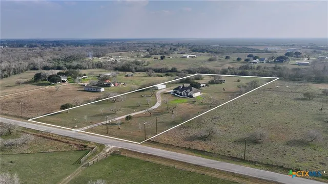 a dining room with furniture and a chandelier