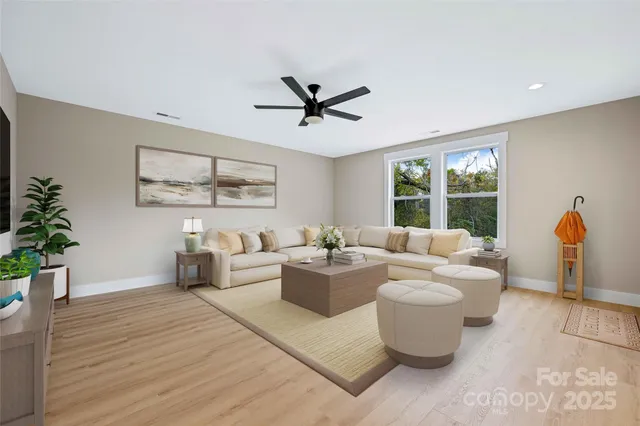a living room with furniture potted plant and a window