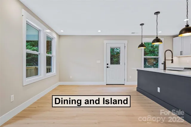 a view of an entryway with wooden floor