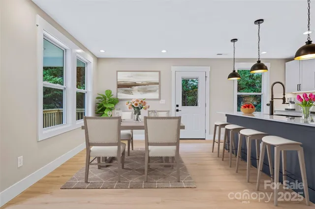 a dining room with furniture window and wooden floor