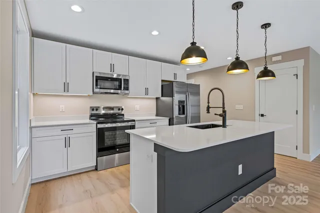 a kitchen with a sink a stove and cabinets