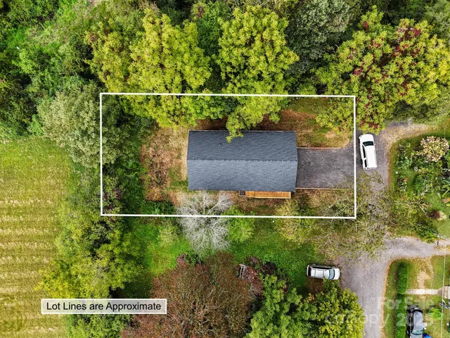 a house view with a fence and a forest
