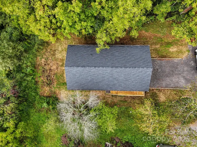 an aerial view of a house with backyard