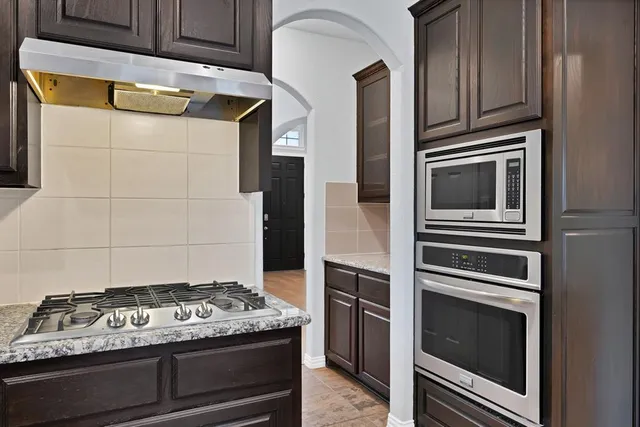 a stove top oven sitting inside of a kitchen