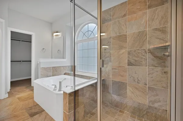 a bathroom with a bathtub and shower