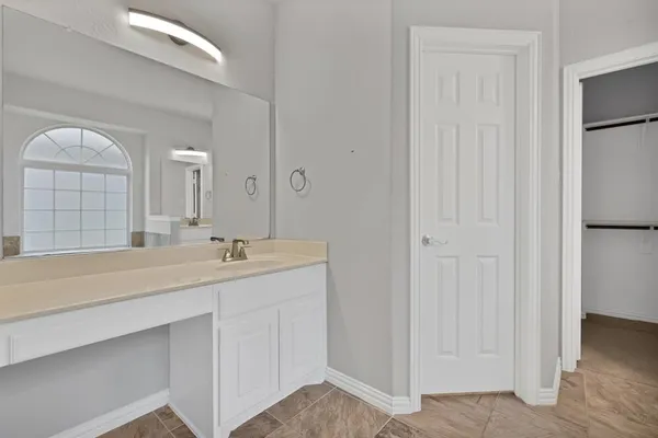 a bathroom with a double vanity sink and a mirror