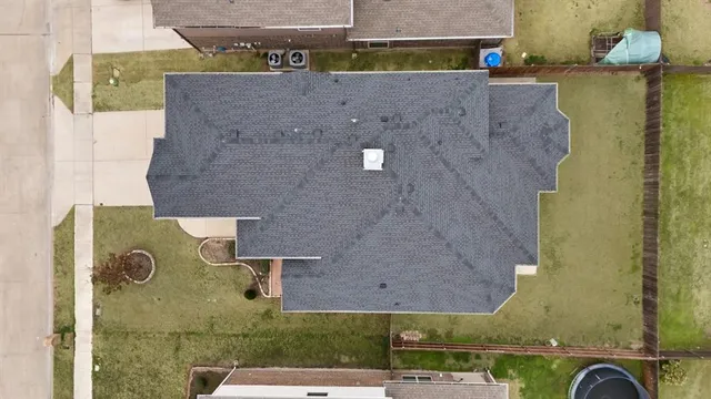 an aerial view of residential houses with outdoor space
