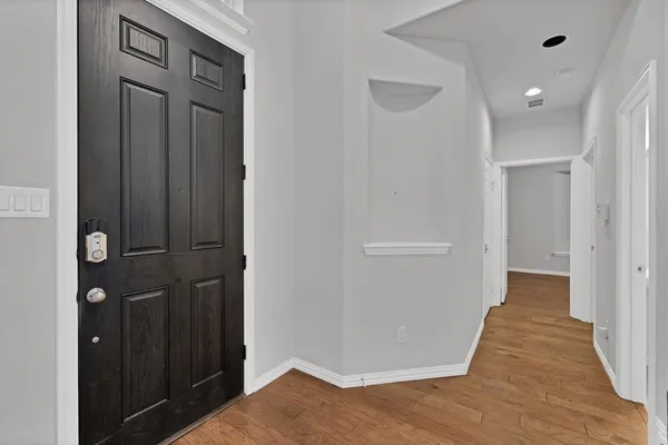 a view of a hallway with wooden floor