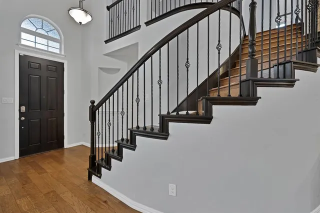 a view of entryway and hall with wooden floor