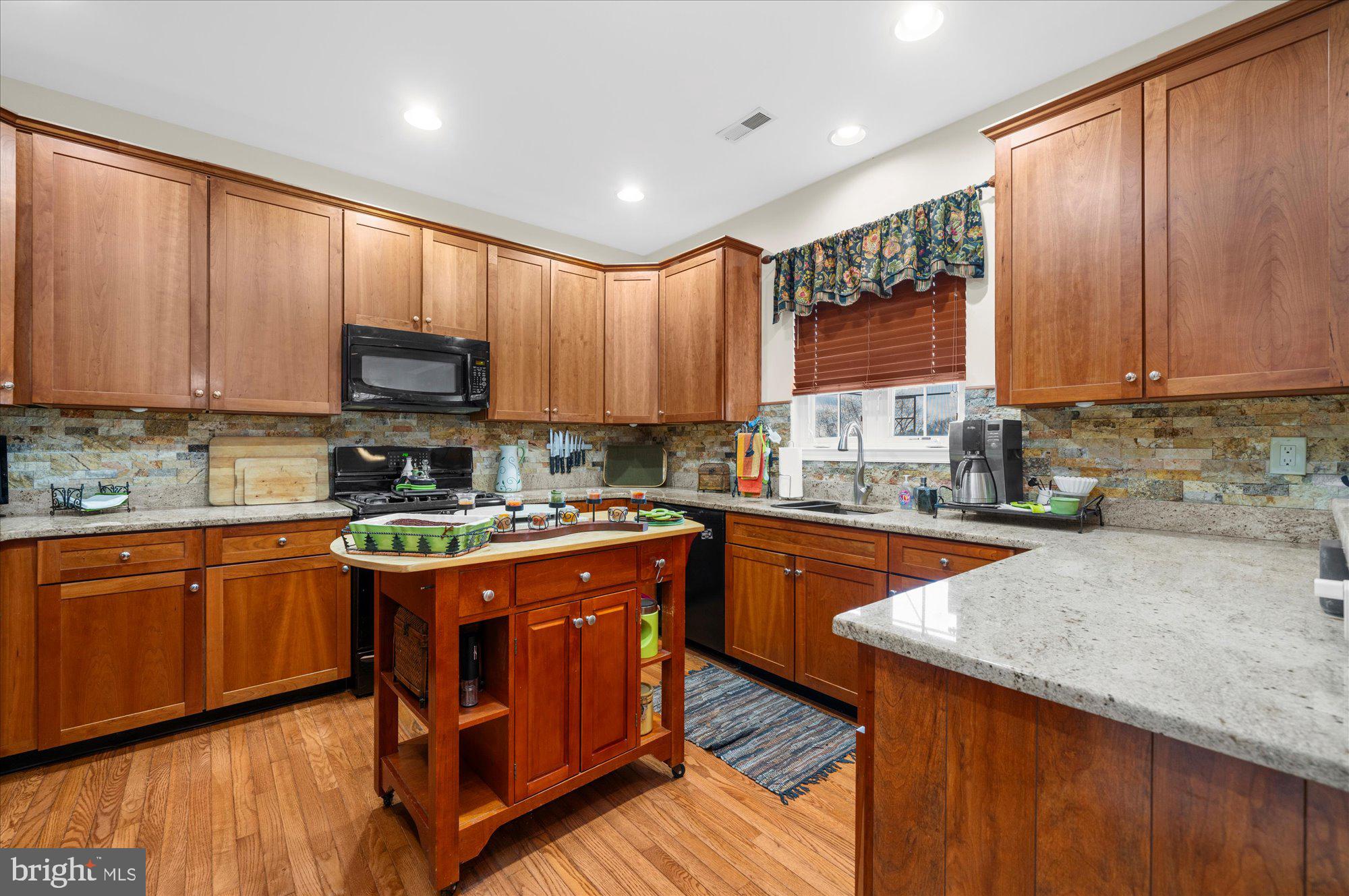 108 Hartman Road Pottstown, PA 19465 - Photo 11 of 38 a kitchen with stainless steel appliances granite countertop wooden cabinets a stove top oven a sink and dishwasher
