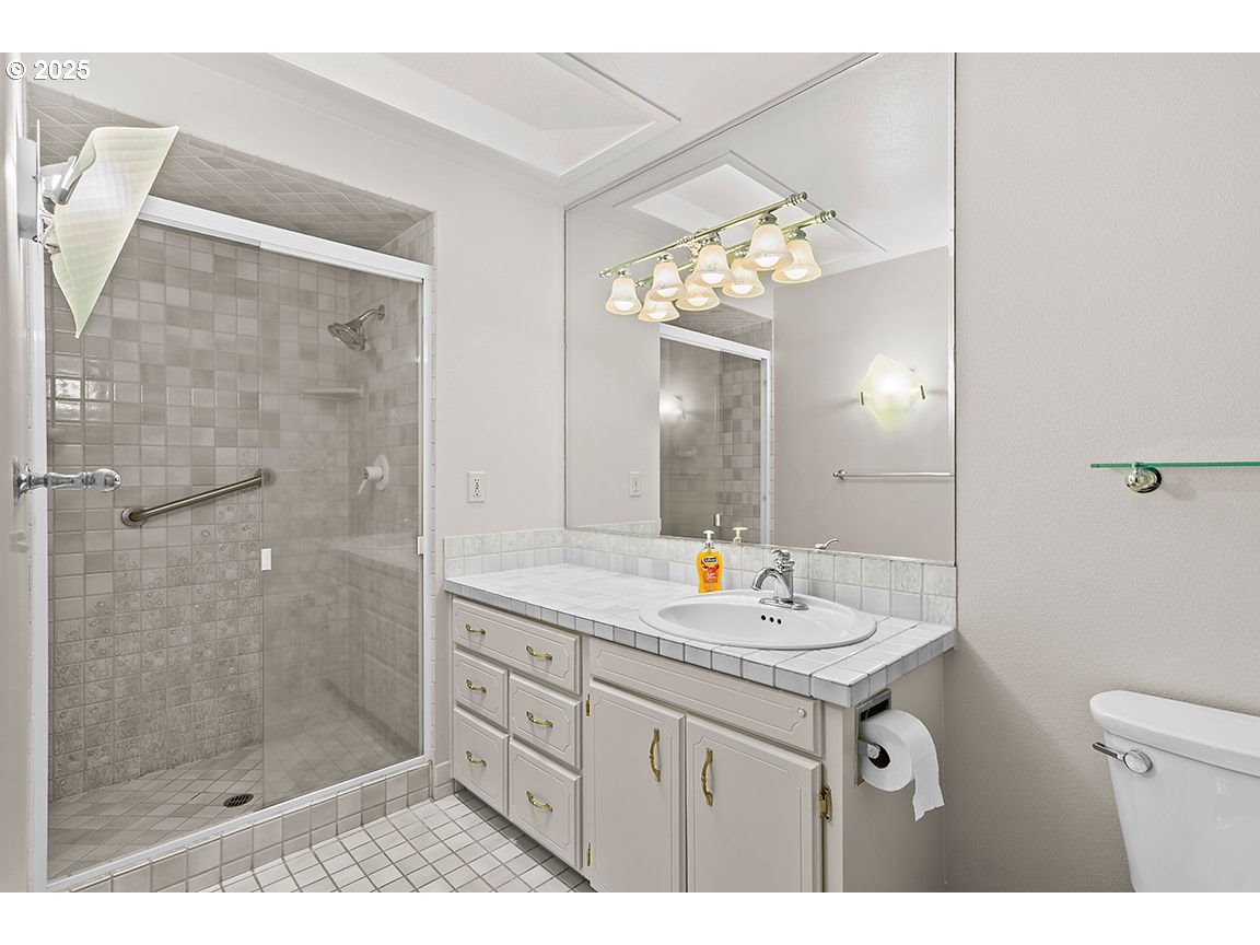 9 Britten Court Lake Oswego, OR 97035 - Photo 31 of 48 a bathroom with a sink shower and a mirror