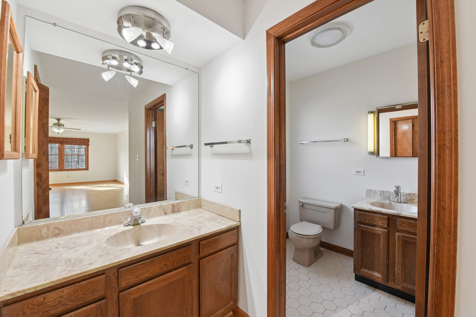 1500 Gordon Terrace Deerfield, IL 60015 - Photo 20 of 36 a bathroom with a granite countertop sink a toilet and a mirror