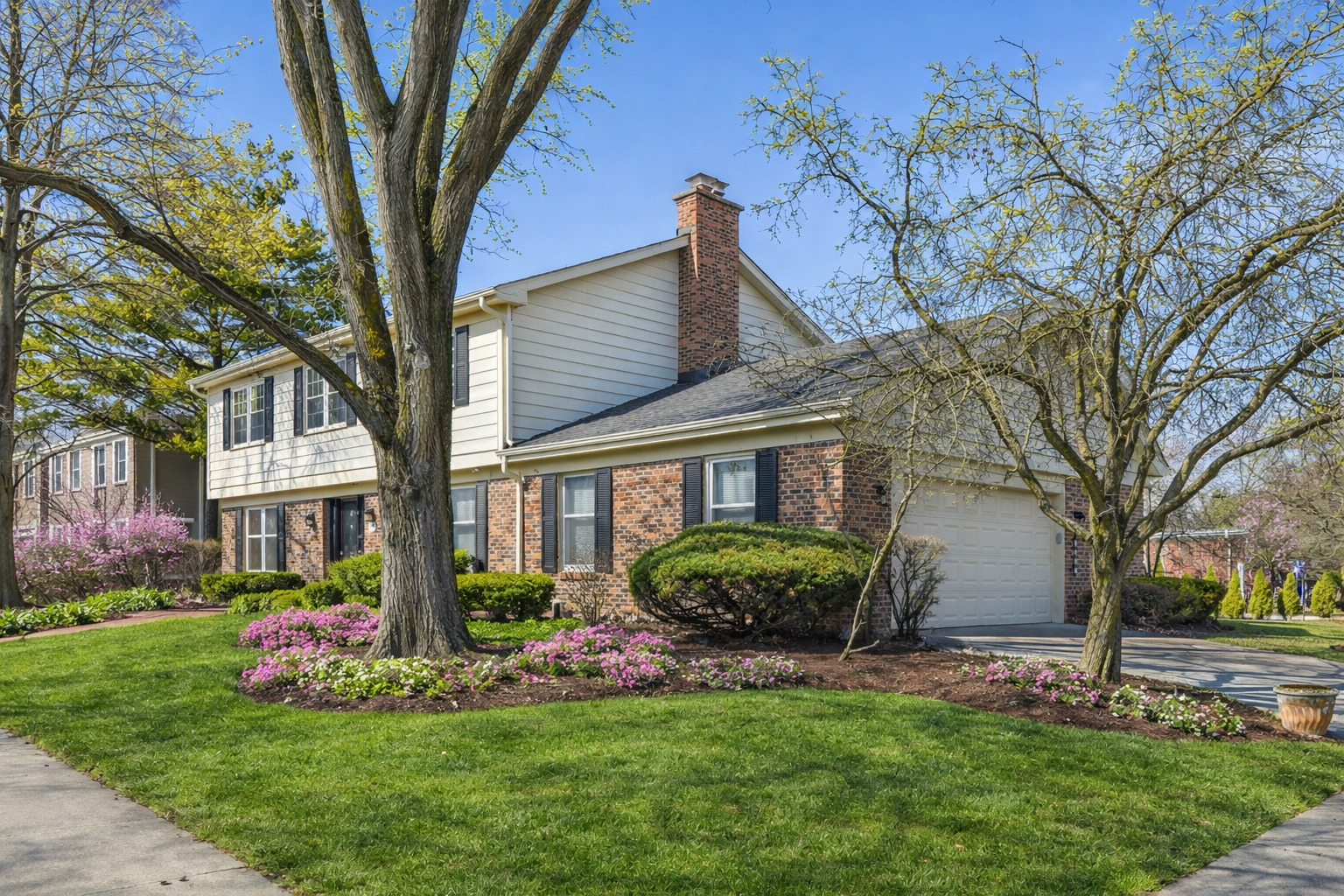 1500 Gordon Terrace Deerfield, IL 60015 - Photo 2 of 36 a front view of a house with a garden and trees
