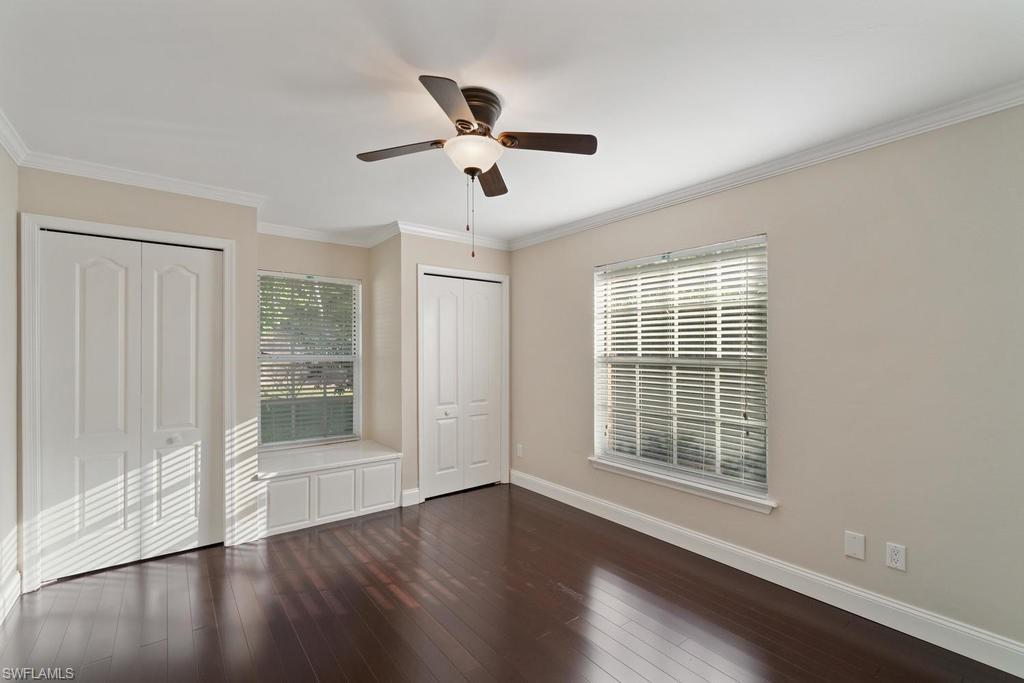560 Henley Drive Naples, FL 34104 - Photo 12 of 16 a view of wooden floor and windows in a room