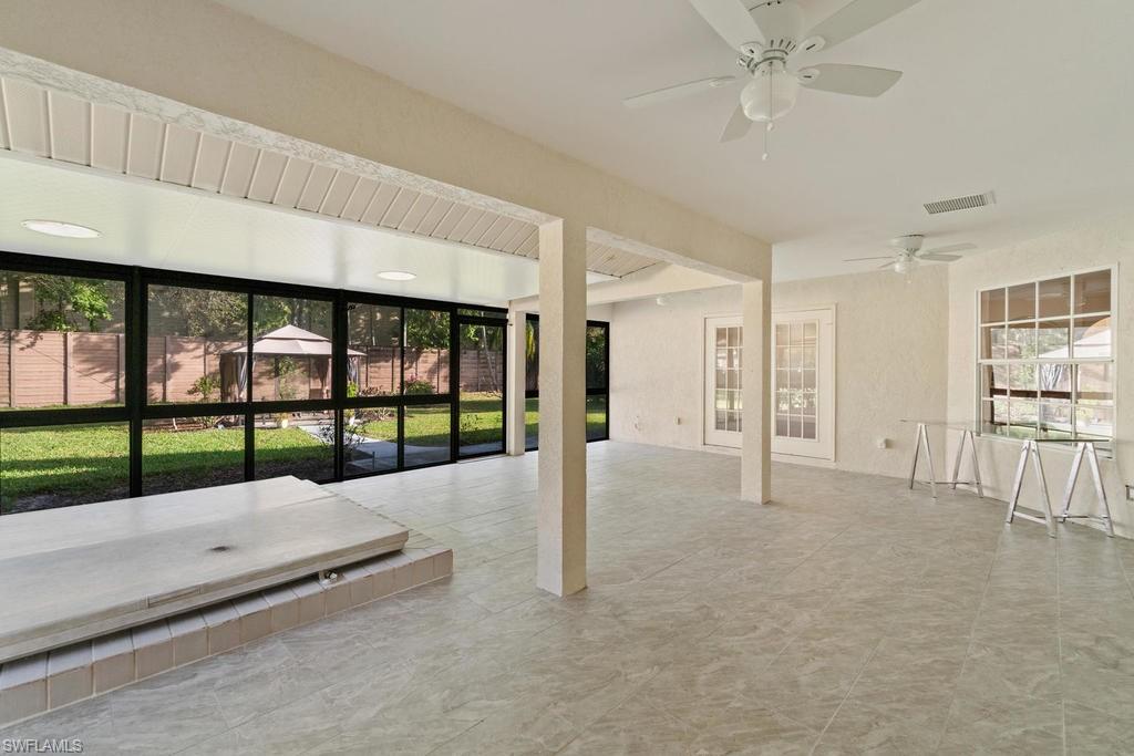 560 Henley Drive Naples, FL 34104 - Photo 15 of 16 a view of an empty room with floor to ceiling window