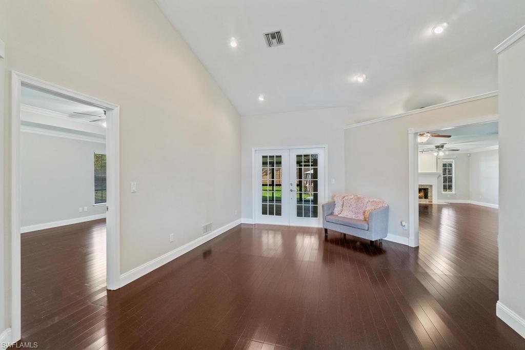 560 Henley Drive Naples, FL 34104 - Photo 2 of 16 a view of a livingroom with wooden floor and furniture
