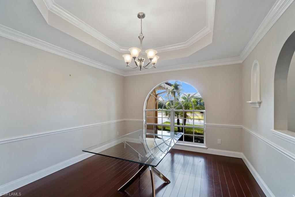 560 Henley Drive Naples, FL 34104 - Photo 8 of 16 a view of a room with furniture large windows and wooden floor