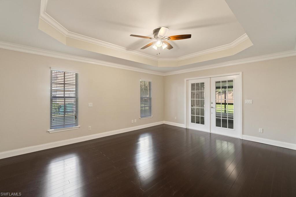 560 Henley Drive Naples, FL 34104 - Photo 9 of 16 a view of an empty room with wooden floor and a window