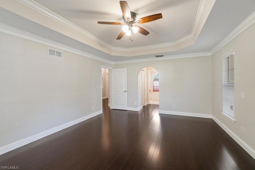 560 Henley Drive Naples, FL 34104 - Photo 10 of 16 wooden floor in an empty room with a window