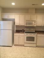 4448 Pheasant Ridge Road, Unit 303 Roanoke, VA 24014 - Photo 3 of 8 a kitchen with granite countertop white cabinets and white appliances