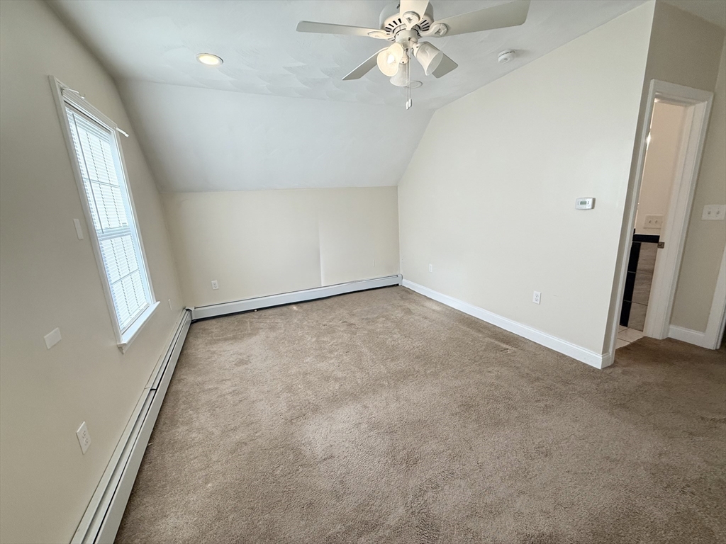592 Westminster Hill Road Fitchburg, MA 01420 - Photo 11 of 21 an empty room with windows and fan