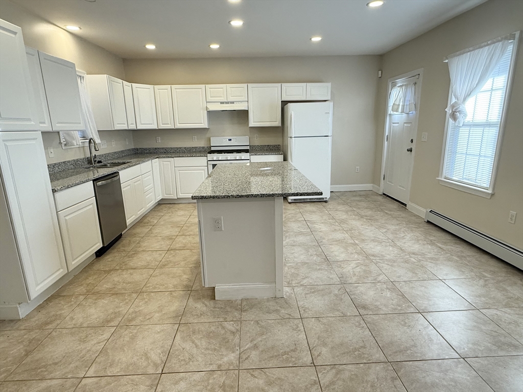 592 Westminster Hill Road Fitchburg, MA 01420 - Photo 3 of 21 a kitchen with granite countertop a stove a sink and a refrigerator