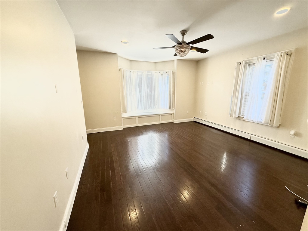 592 Westminster Hill Road Fitchburg, MA 01420 - Photo 5 of 21 a view of a livingroom with wooden floor and a ceiling fan