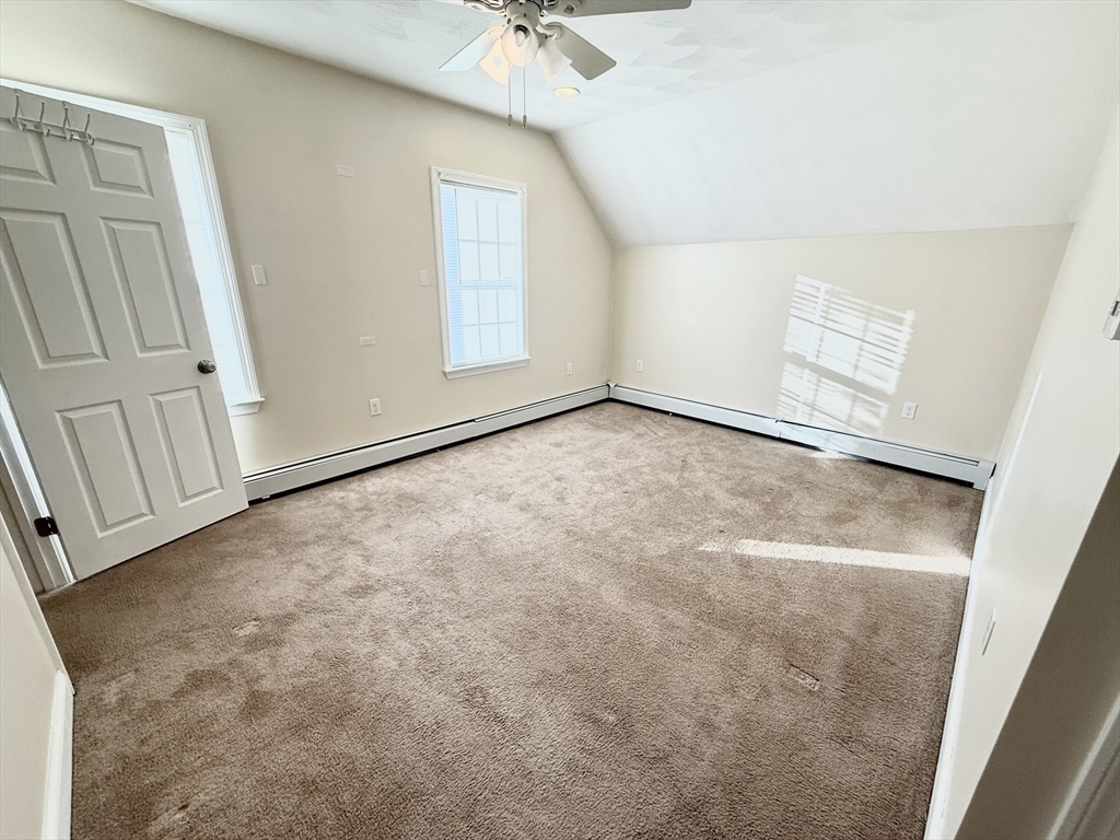 592 Westminster Hill Road Fitchburg, MA 01420 - Photo 10 of 21 an empty room with a ceiling fan and windows