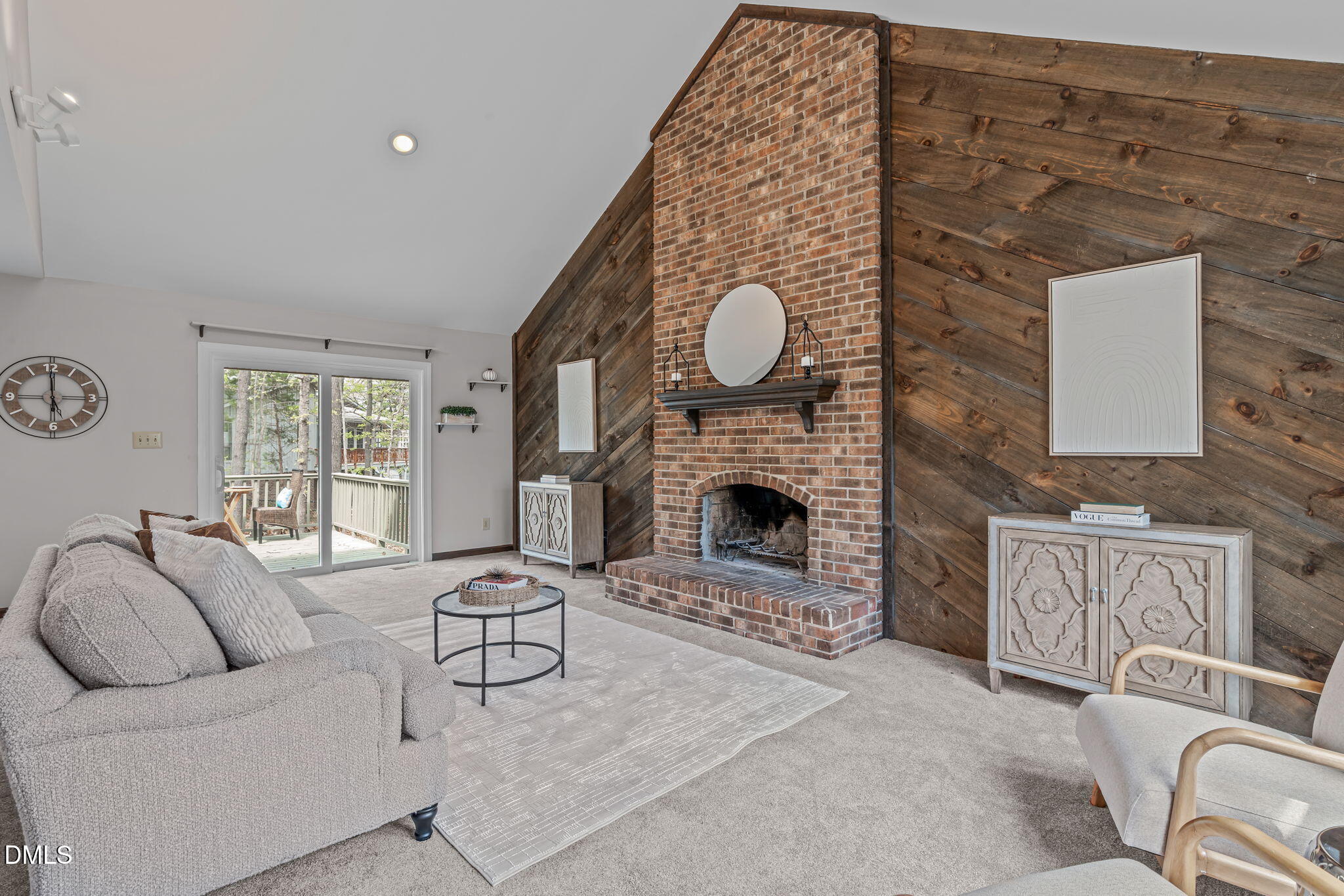 3304 Wade Avenue Raleigh, NC 27607 - Photo 4 of 38 a living room with furniture a fireplace and a floor to ceiling window