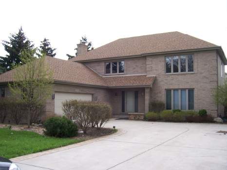 1010 North Elmhurst Road Mount Prospect, IL 60056 - Photo 1 of 1 a front view of a house with a yard