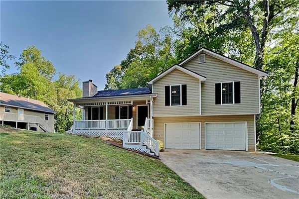 a front view of a house with a garden
