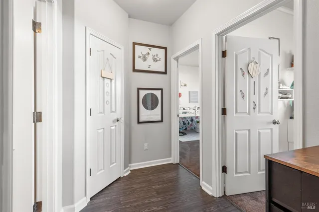 a view of a hallway with wooden floor