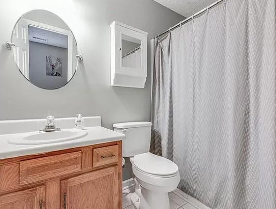 1565 Springleaf Court Southeast Smyrna, GA 30080 - Photo 17 of 23 a bathroom with a sink vanity mirror and toilet