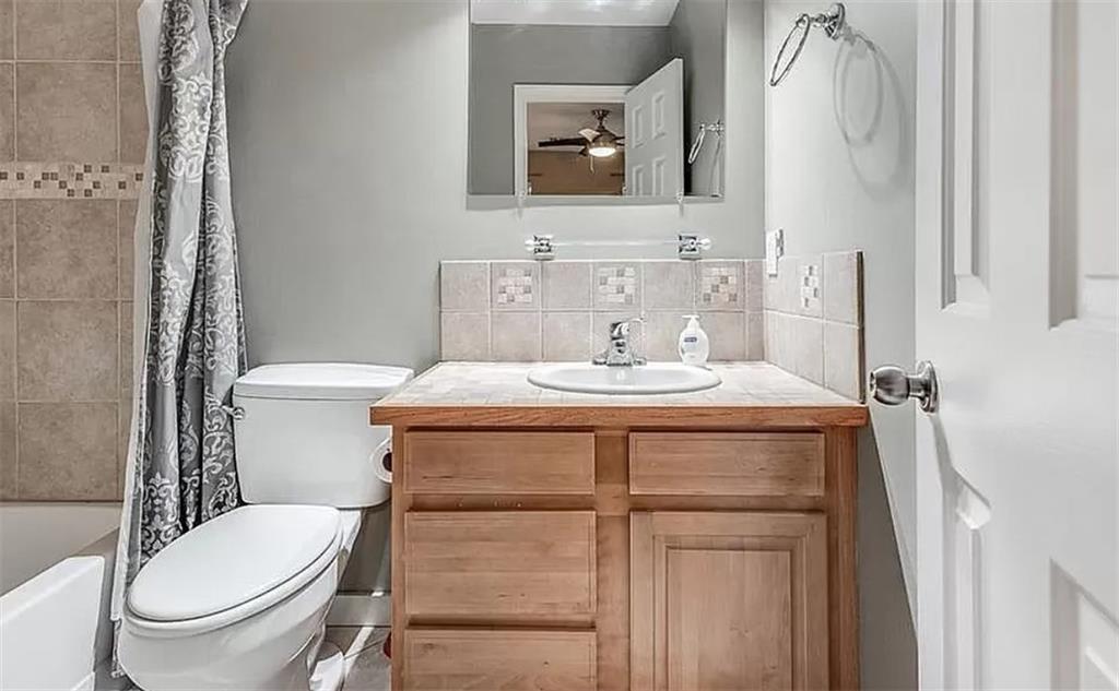 1565 Springleaf Court Southeast Smyrna, GA 30080 - Photo 19 of 23 a bathroom with a toilet sink vanity and mirror