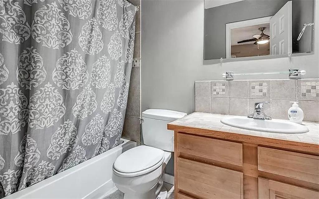 1565 Springleaf Court Southeast Smyrna, GA 30080 - Photo 20 of 23 a bathroom with a granite countertop sink mirror vanity and toilet
