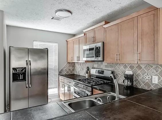 1565 Springleaf Court Southeast Smyrna, GA 30080 - Photo 2 of 23 a kitchen with stainless steel appliances granite countertop a stove a refrigerator and a sink