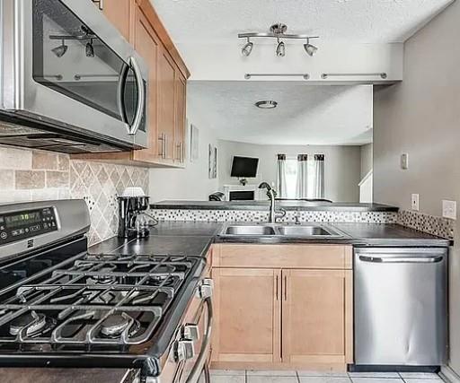 1565 Springleaf Court Southeast Smyrna, GA 30080 - Photo 3 of 23 a kitchen with stainless steel appliances granite countertop a stove and a microwave