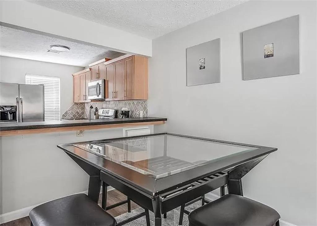1565 Springleaf Court Southeast Smyrna, GA 30080 - Photo 8 of 23 a kitchen with a table chairs sink and cabinets