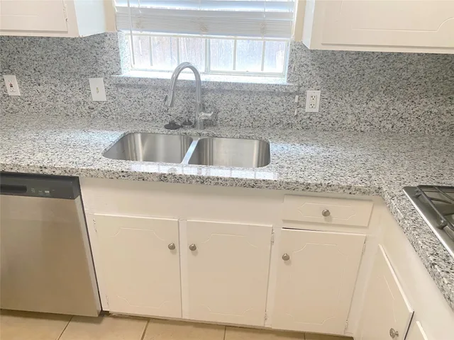 a close view of a sink and granite counter top a sink