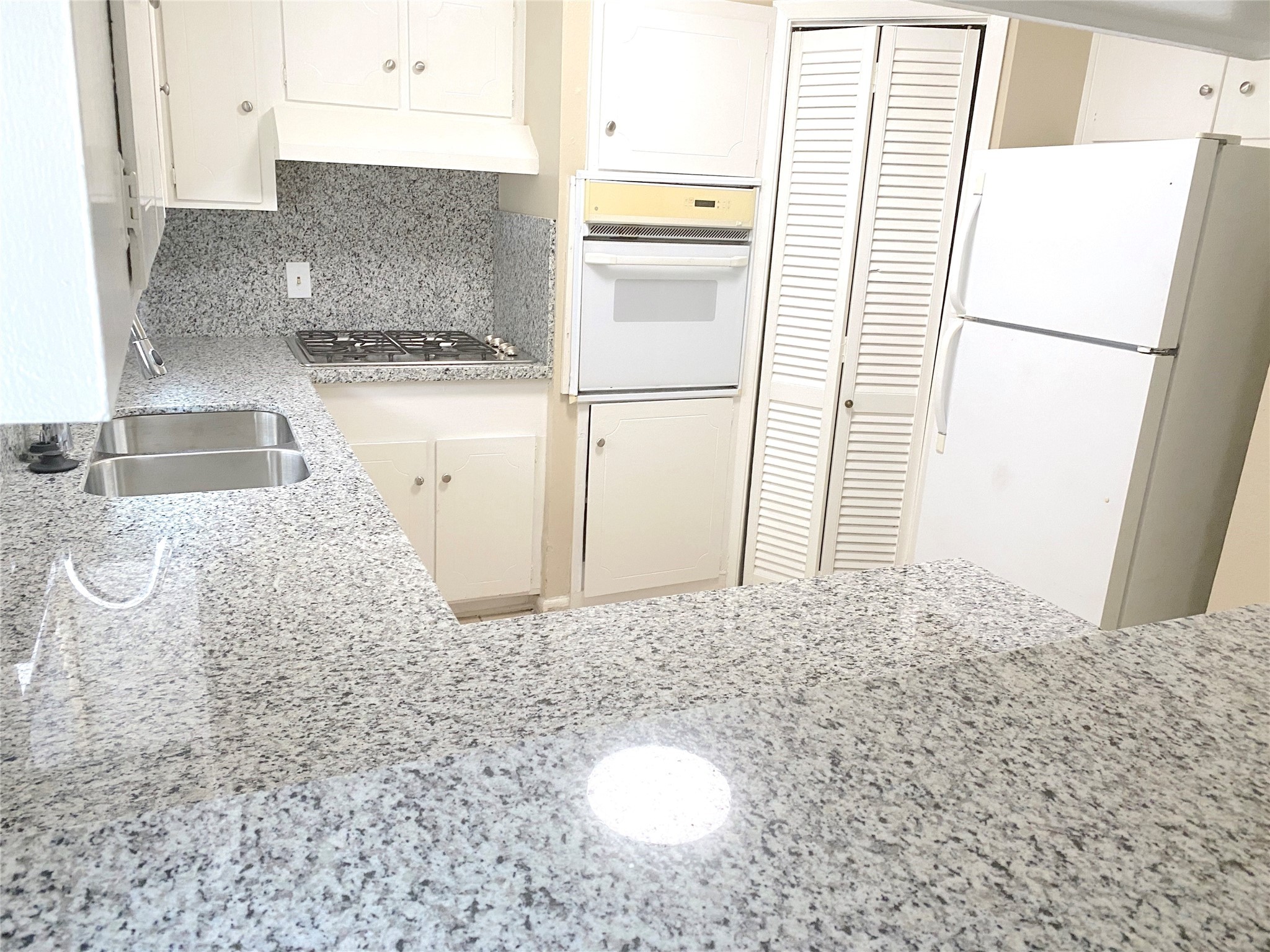 1403 Blalock Road, Unit 12 Houston, TX 77055 - Photo 7 of 15 a kitchen with a refrigerator sink stove and cabinets