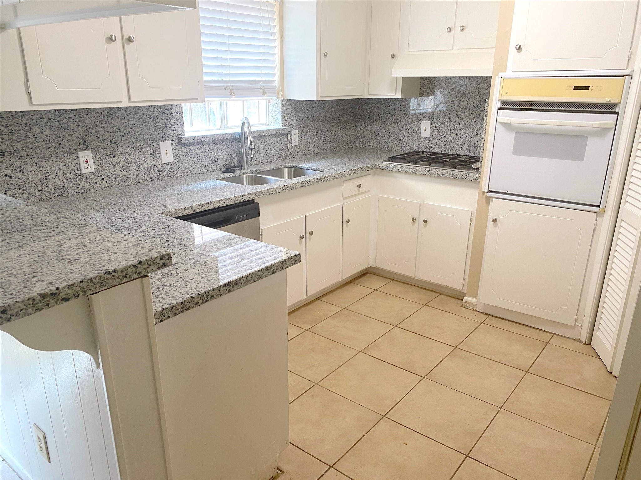 1403 Blalock Road, Unit 12 Houston, TX 77055 - Photo 8 of 15 a kitchen with a sink a stove top oven and cabinets