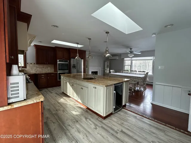 a kitchen with stainless steel appliances granite countertop a stove and a sink