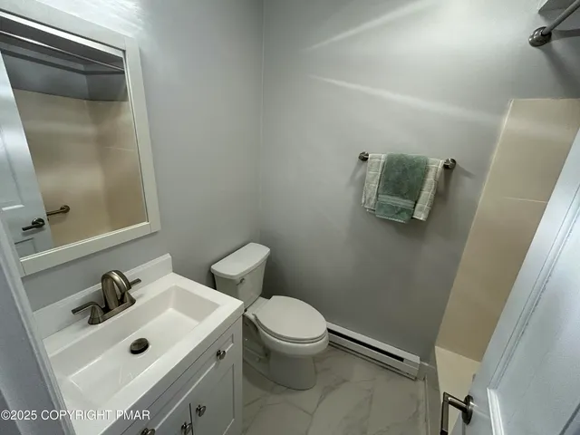 a bathroom with a sink mirror and toilet