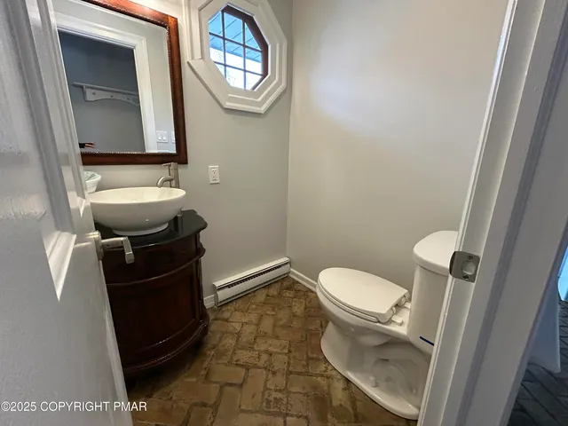 a bathroom with a toilet and a mirror