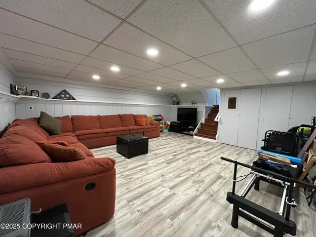 a living room with furniture a wooden floor and chairs