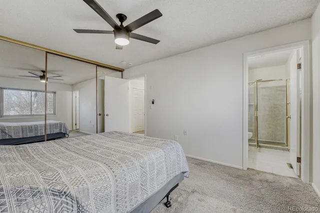 a bedroom with a bed and a glass door