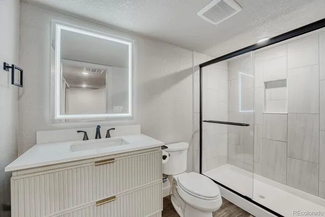 a bathroom with a sink toilet and shower