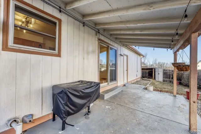 a view of a bench and trees in the background